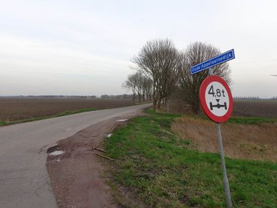 Begin van een dijkweg bij Fijnaart. Links een verkeersbord.